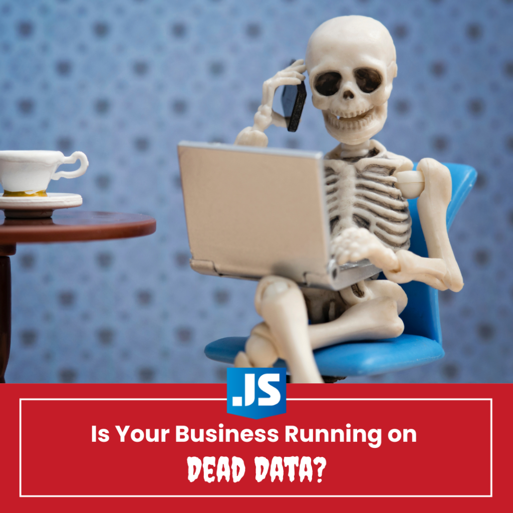 skeleton sitting on chair while on cell phone and holding laptop